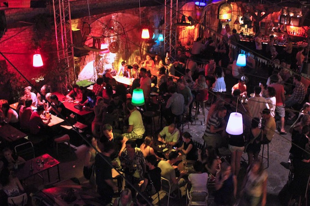 Crowd sitting at Szimpla Kert Ruin Bar