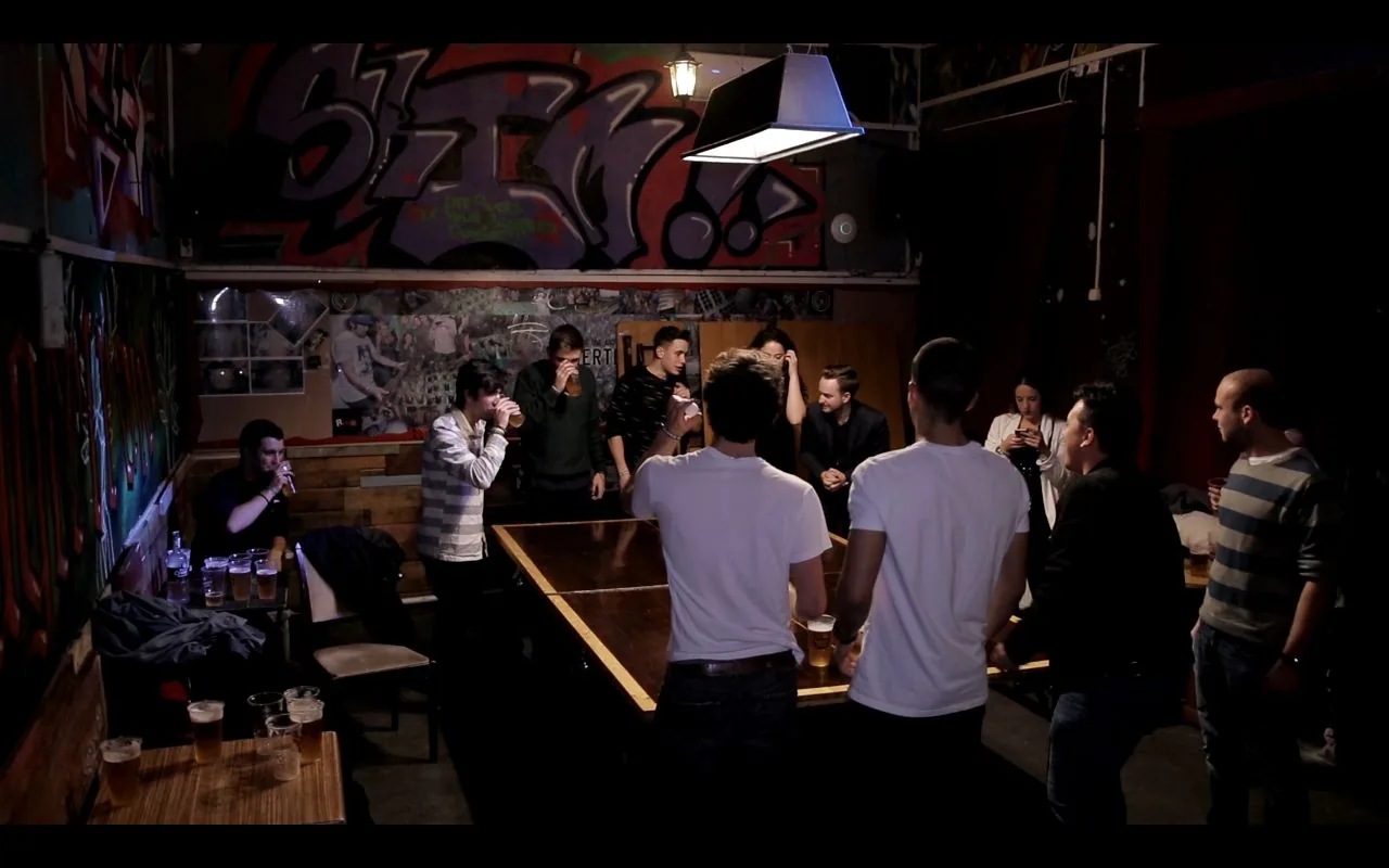 A group playing beer pong under graffiti-covered walls at Retox Party Hostel, Budapest