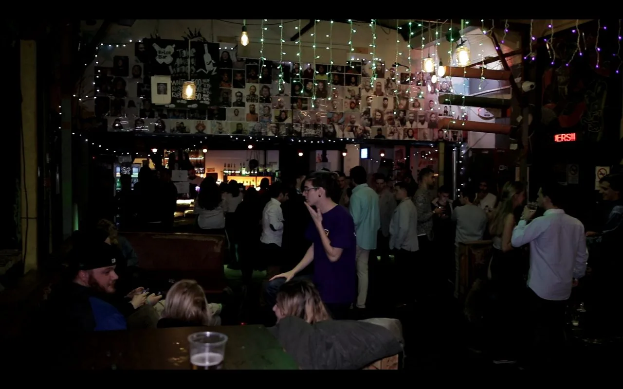 Late-night drinking games and a rowdy crowd at Retox Party Hostel bar, Budapest