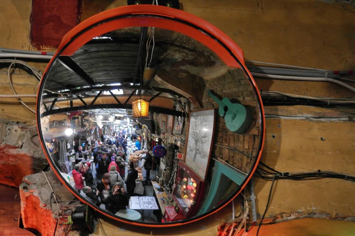 Colourful hanging lamps glowing over the crowd at Szimpla Kert, Budapest